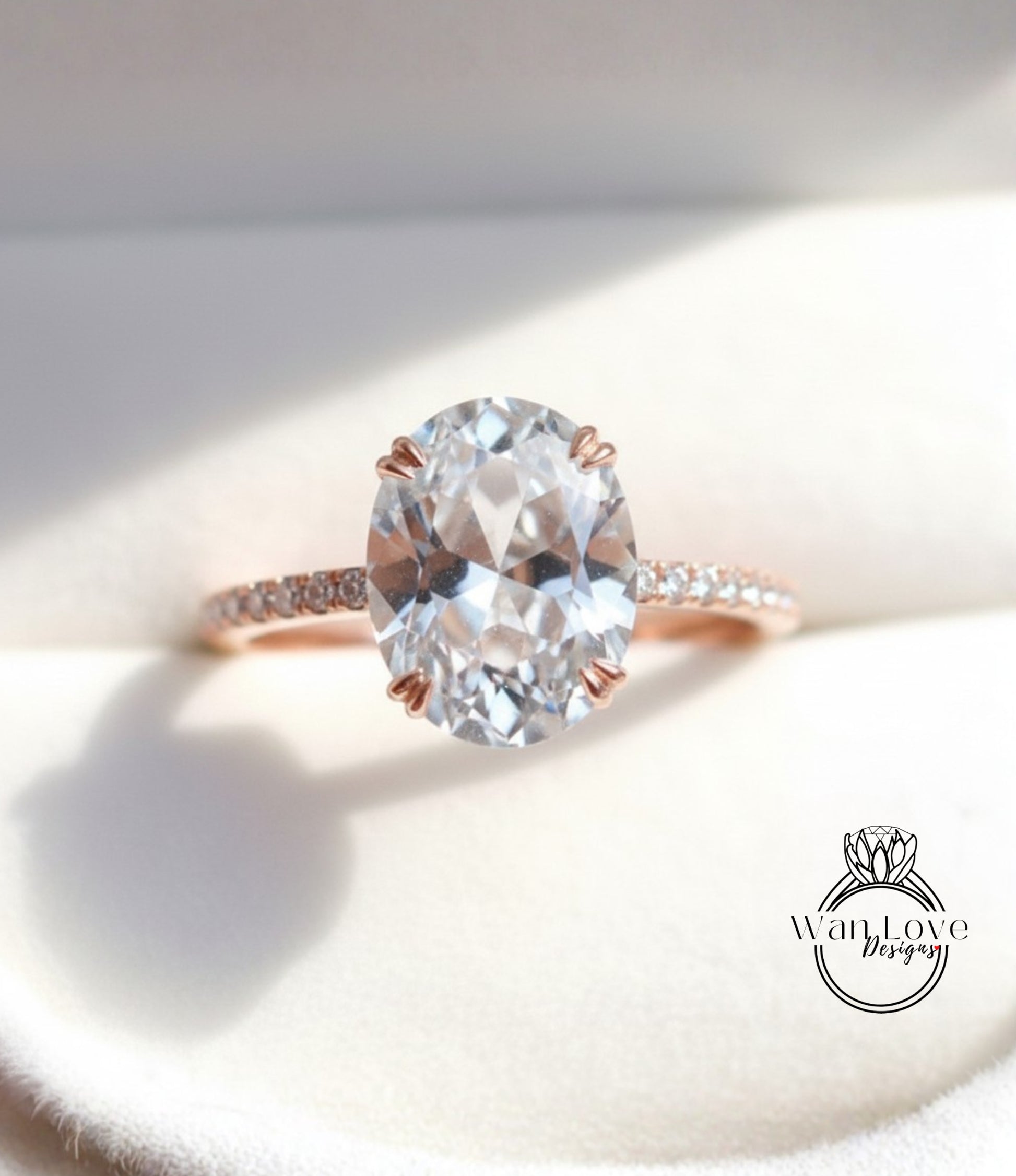 A close-up image of a diamond engagement ring with a large oval-shaped diamond set in a rose gold band.