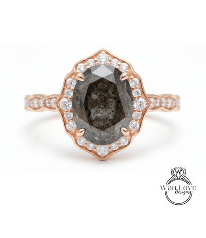 a beautiful engagement ring with a large oval-shaped diamond set in a rose gold band, surrounded by smaller diamonds.