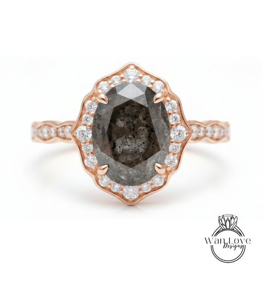 a beautiful engagement ring with a large oval-shaped diamond set in a rose gold band, surrounded by smaller diamonds.