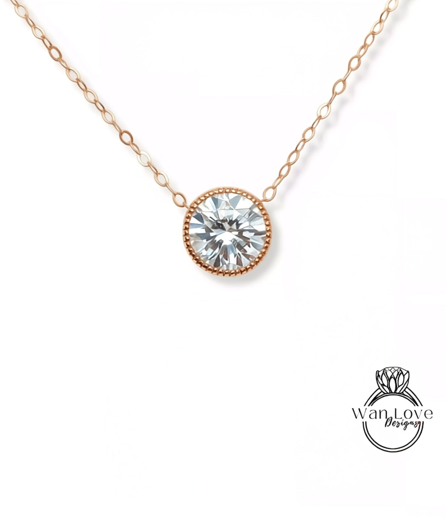 A delicate gold necklace with a large, round diamond pendant.