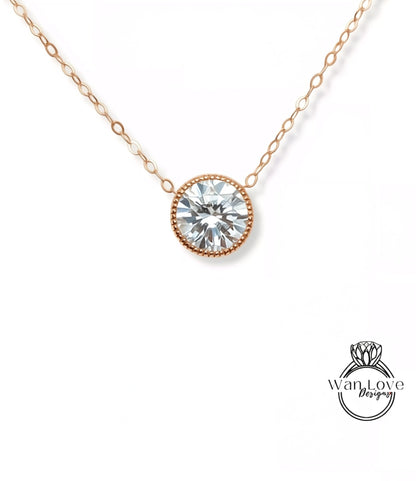 A delicate gold necklace with a large, round diamond pendant.