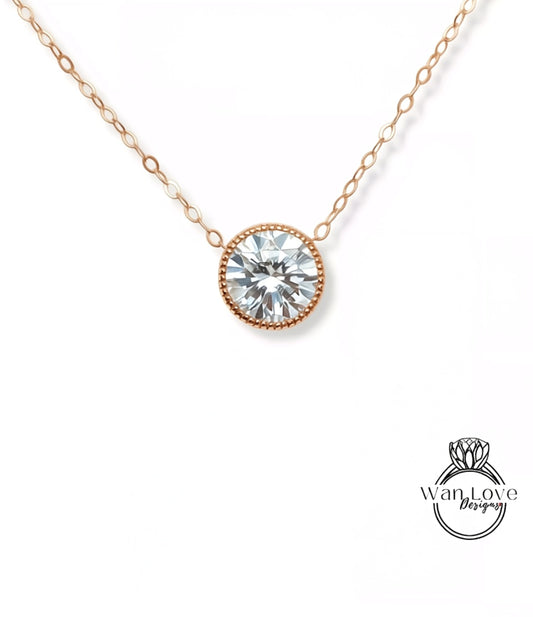 A delicate gold necklace with a large, round diamond pendant.