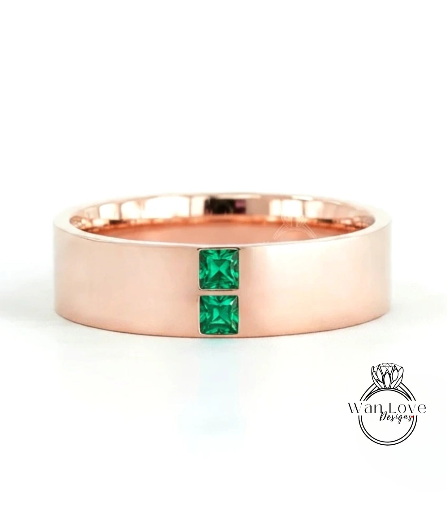A rose gold ring with a large central gemstone and two smaller gemstones on either side.
