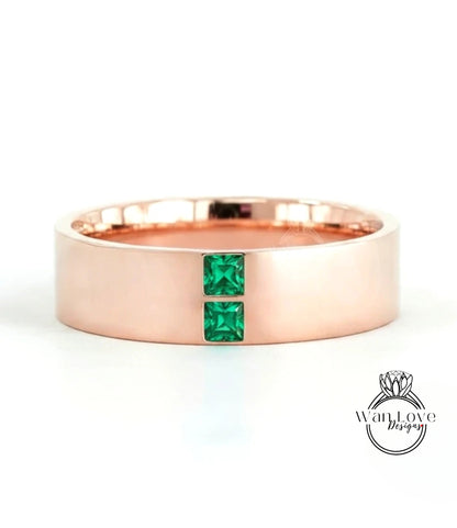 A rose gold ring with a large central gemstone and two smaller gemstones on either side.