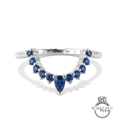 A silver ring with a large blue gemstone in the center, surrounded by smaller blue gemstones.