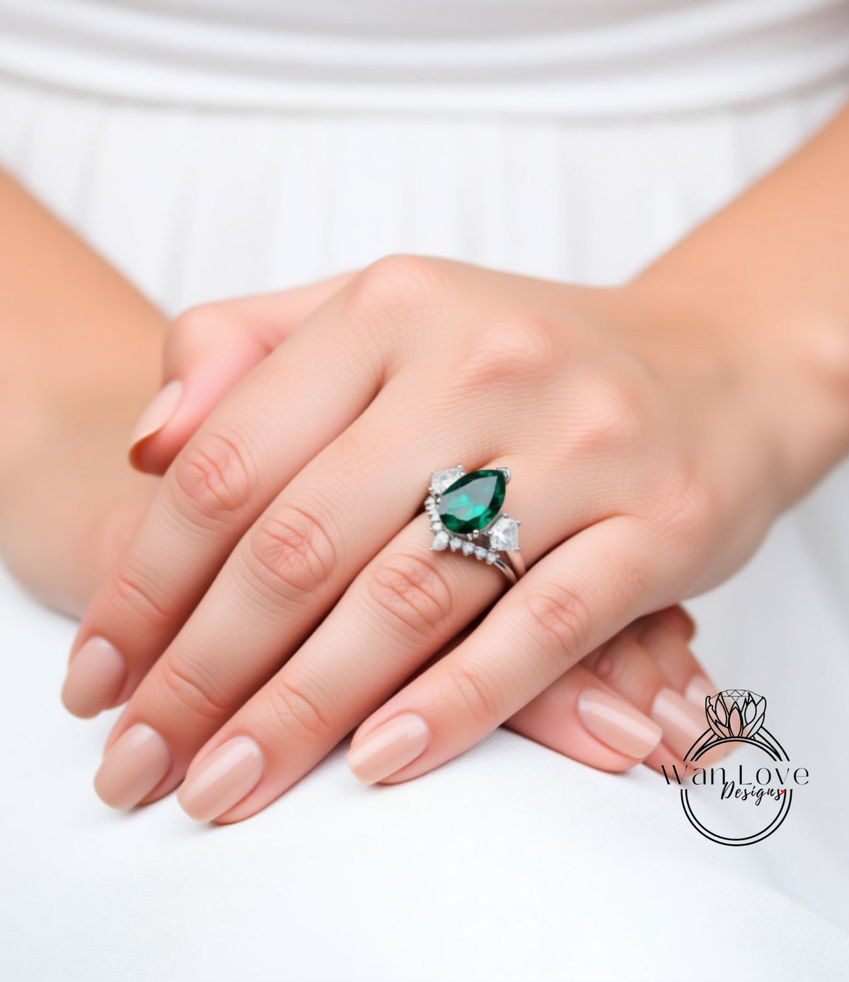 A close-up of a person's hand wearing a ring with a large green gemstone.