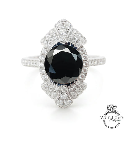 A stunning diamond ring with a large black gemstone at its center, surrounded by a sparkling array of diamonds.