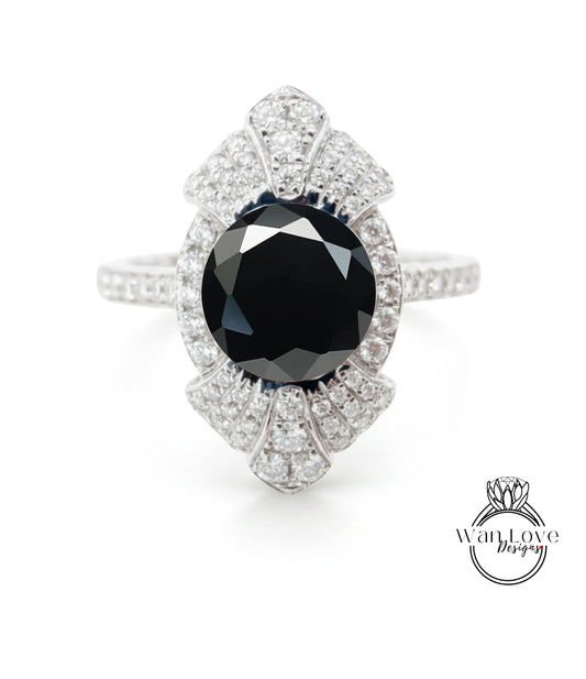 A stunning diamond ring with a large black gemstone at its center, surrounded by a sparkling array of diamonds.