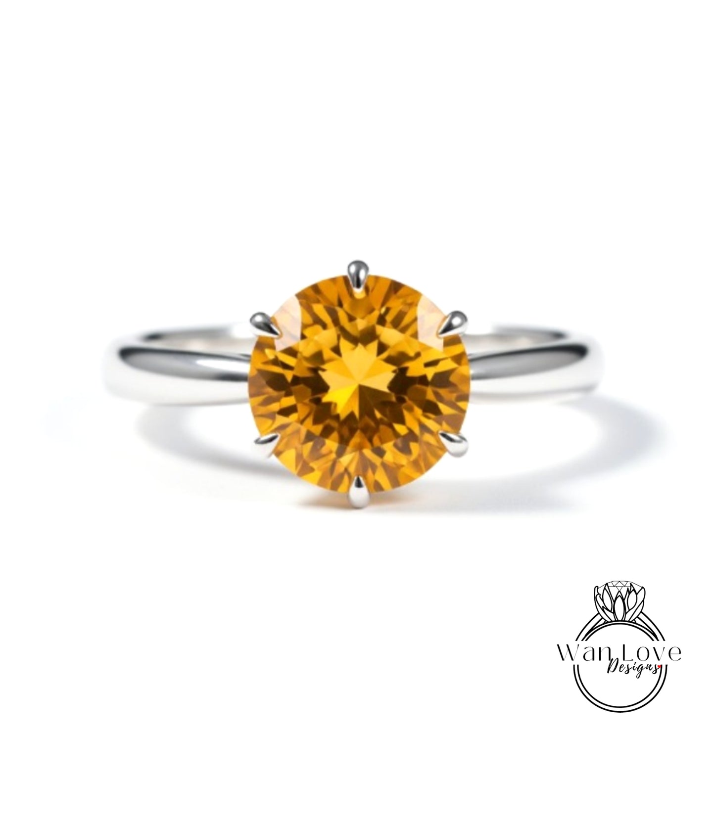 A close-up image of a silver ring with a large, bright yellow gemstone, which appears to be a diamond.