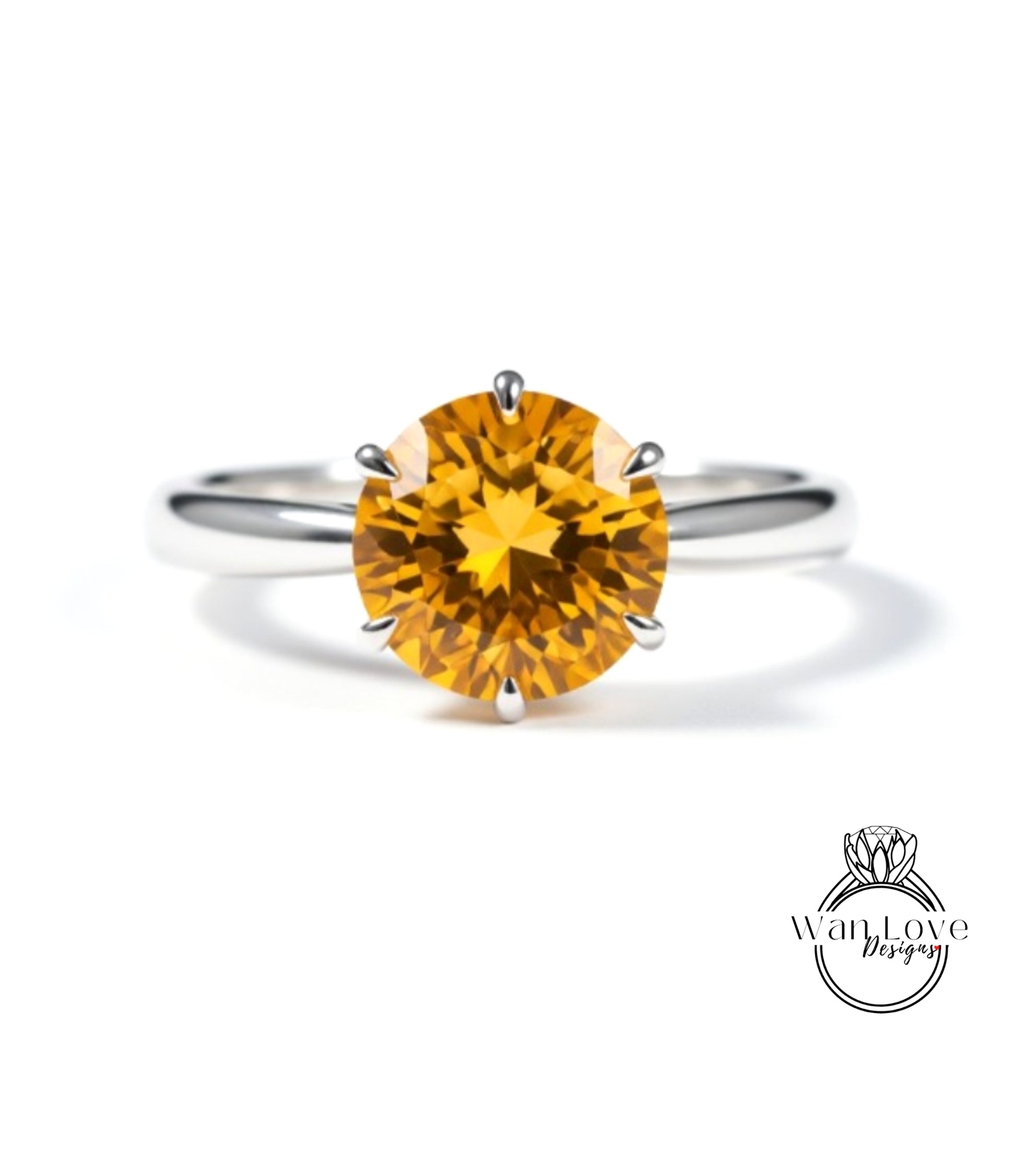 A close-up image of a silver ring with a large, bright yellow gemstone, which appears to be a diamond.