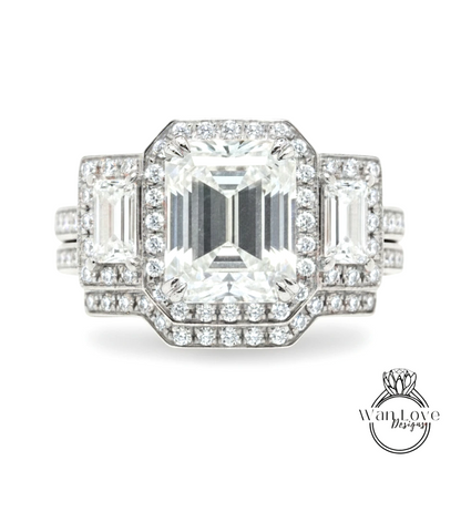 A stunning diamond engagement ring with a large central diamond surrounded by smaller diamonds on either side, set in a silver band.