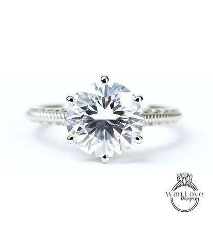 A close-up view of a diamond engagement ring with a large, brilliant-cut diamond set in a silver band.