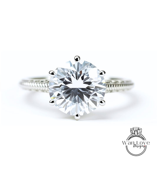 A close-up view of a diamond engagement ring with a large, brilliant-cut diamond set in a silver band.