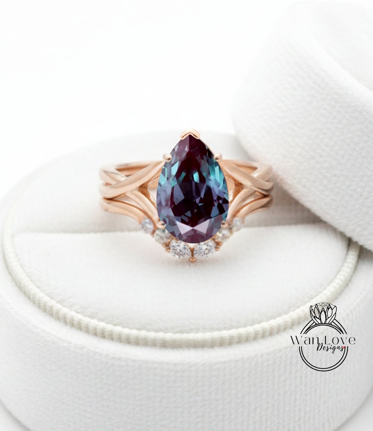 A gold ring with a large purple gemstone, possibly a pear-shaped gemstone, set in a ring band with smaller diamonds.