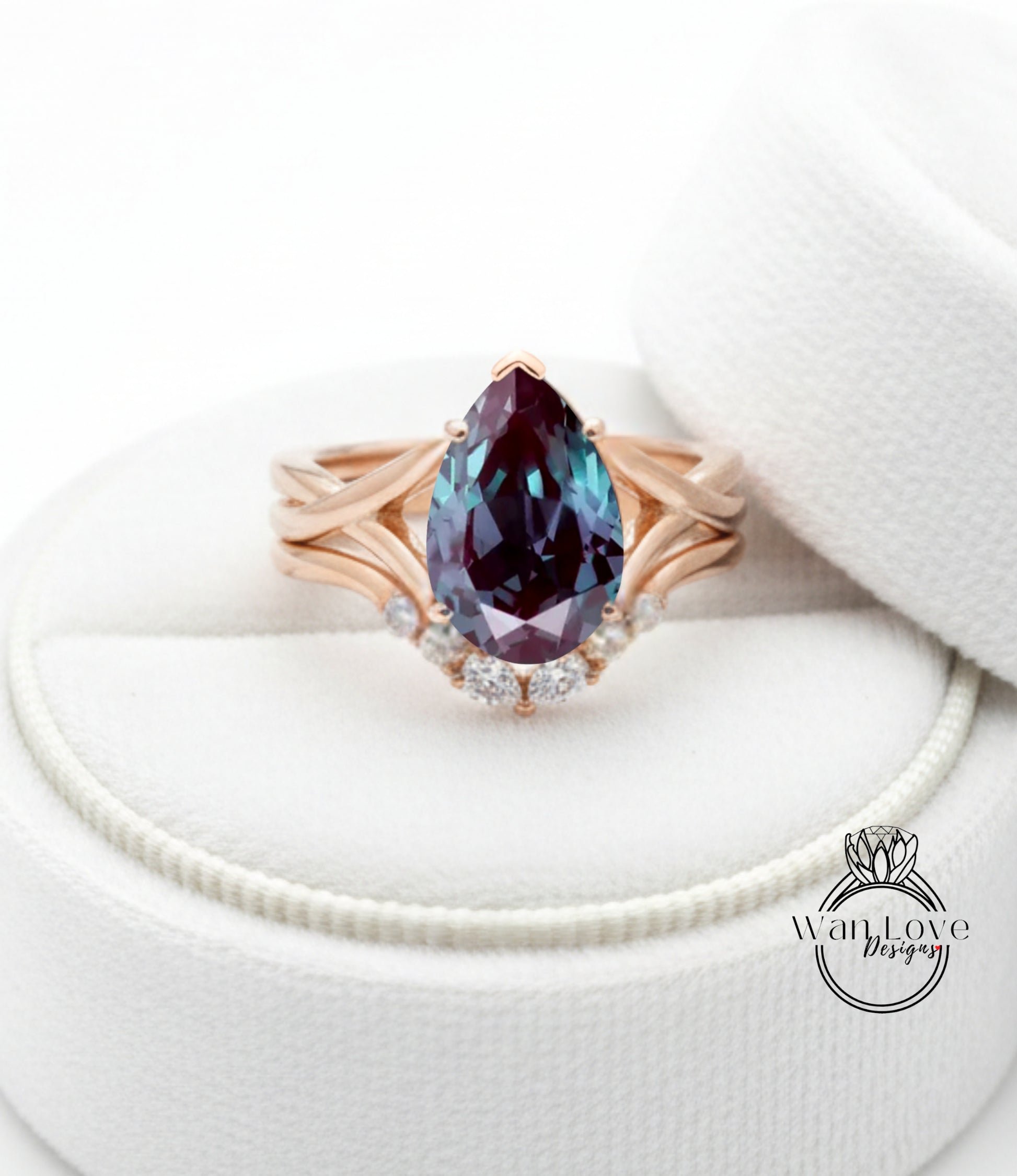 A gold ring with a large purple gemstone, possibly a pear-shaped gemstone, set in a ring band with smaller diamonds.