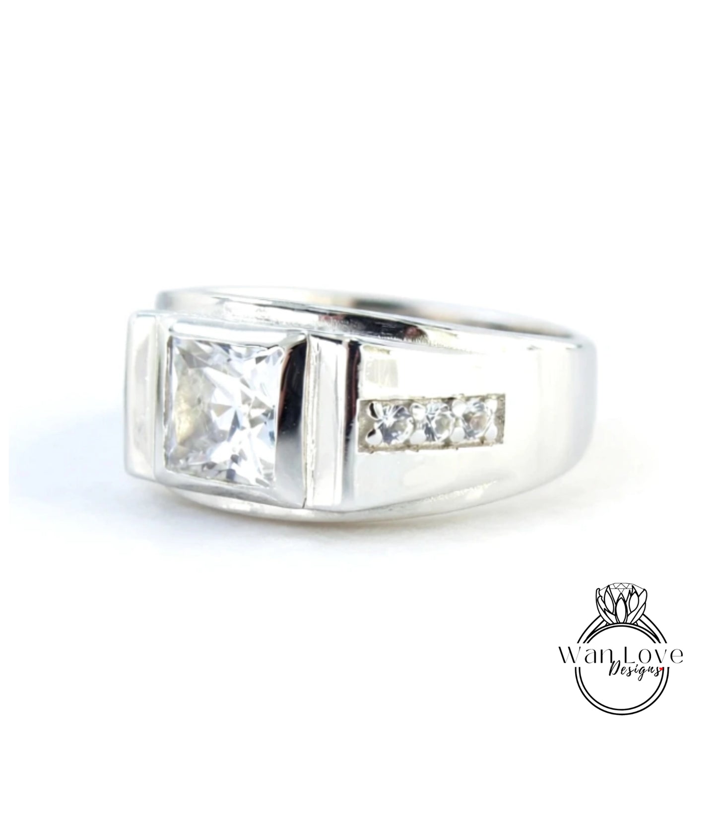 A silver ring with a large diamond in the center, surrounded by smaller diamonds.