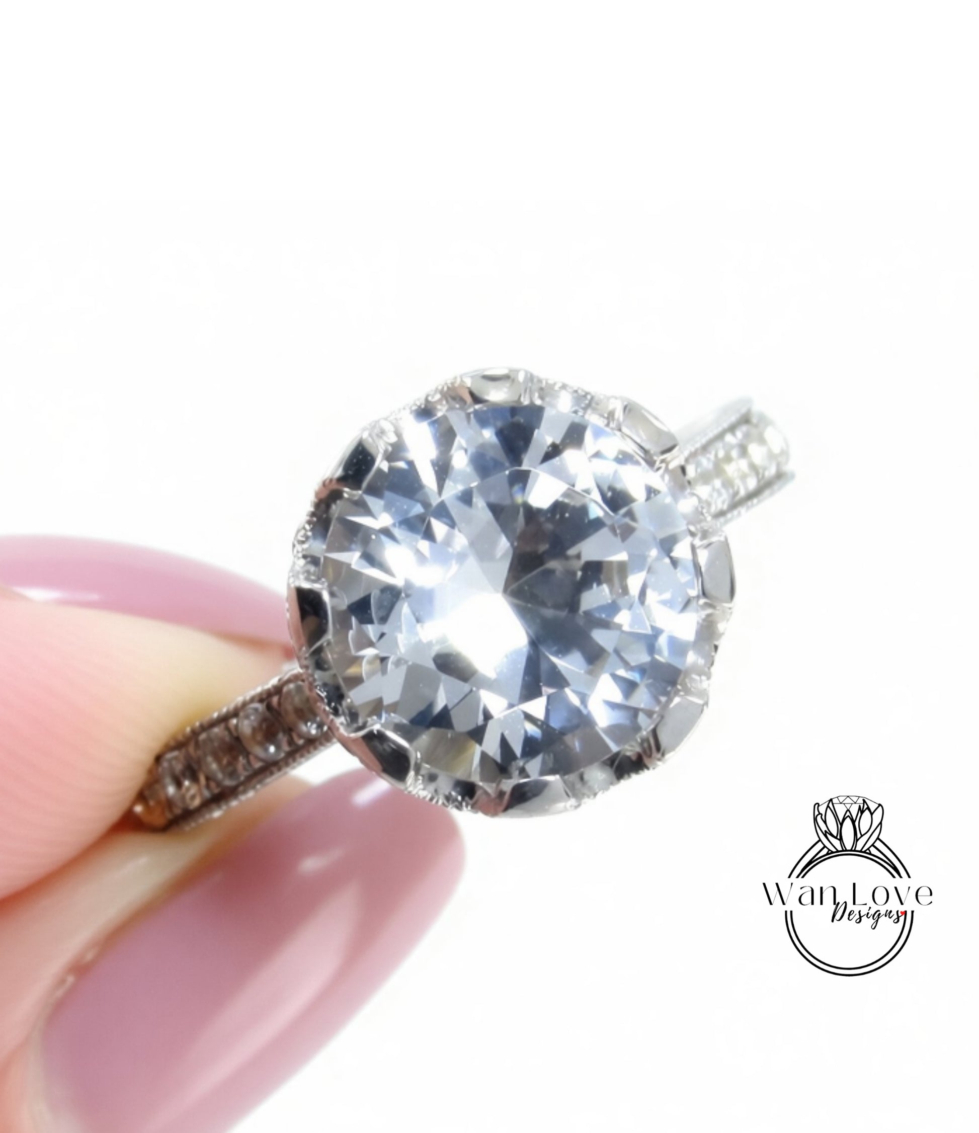 A close-up of a person's hand holding a diamond engagement ring with a large, clear gemstone.