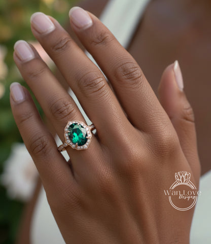 A close-up of a person's hand wearing a gold ring with a large oval-shaped green gemstone.