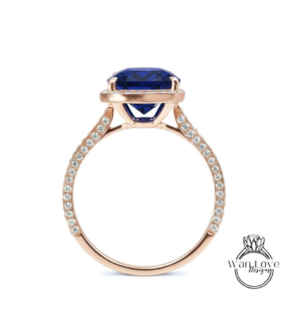 A gold ring with a large blue gemstone set in the center, surrounded by smaller diamonds.