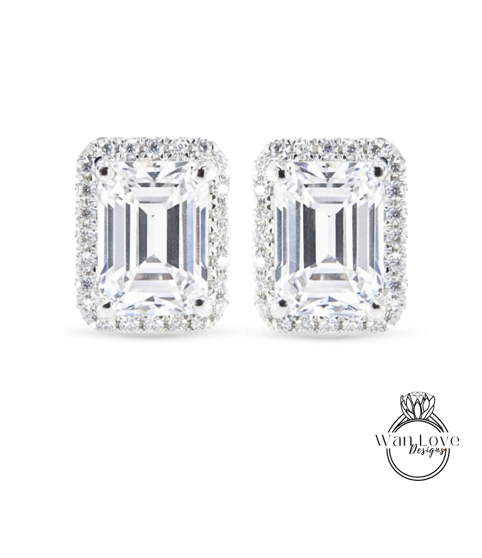 A pair of elegant earrings with large, clear gemstones set in a halo of smaller diamonds.