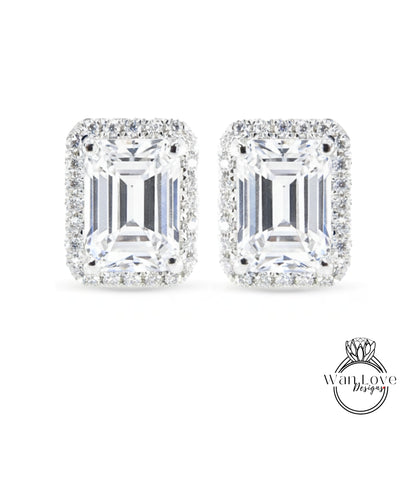 A pair of elegant earrings with large, clear gemstones set in a halo of smaller diamonds.