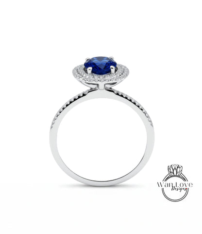 A silver ring with a large blue gemstone at the center, surrounded by smaller diamonds.