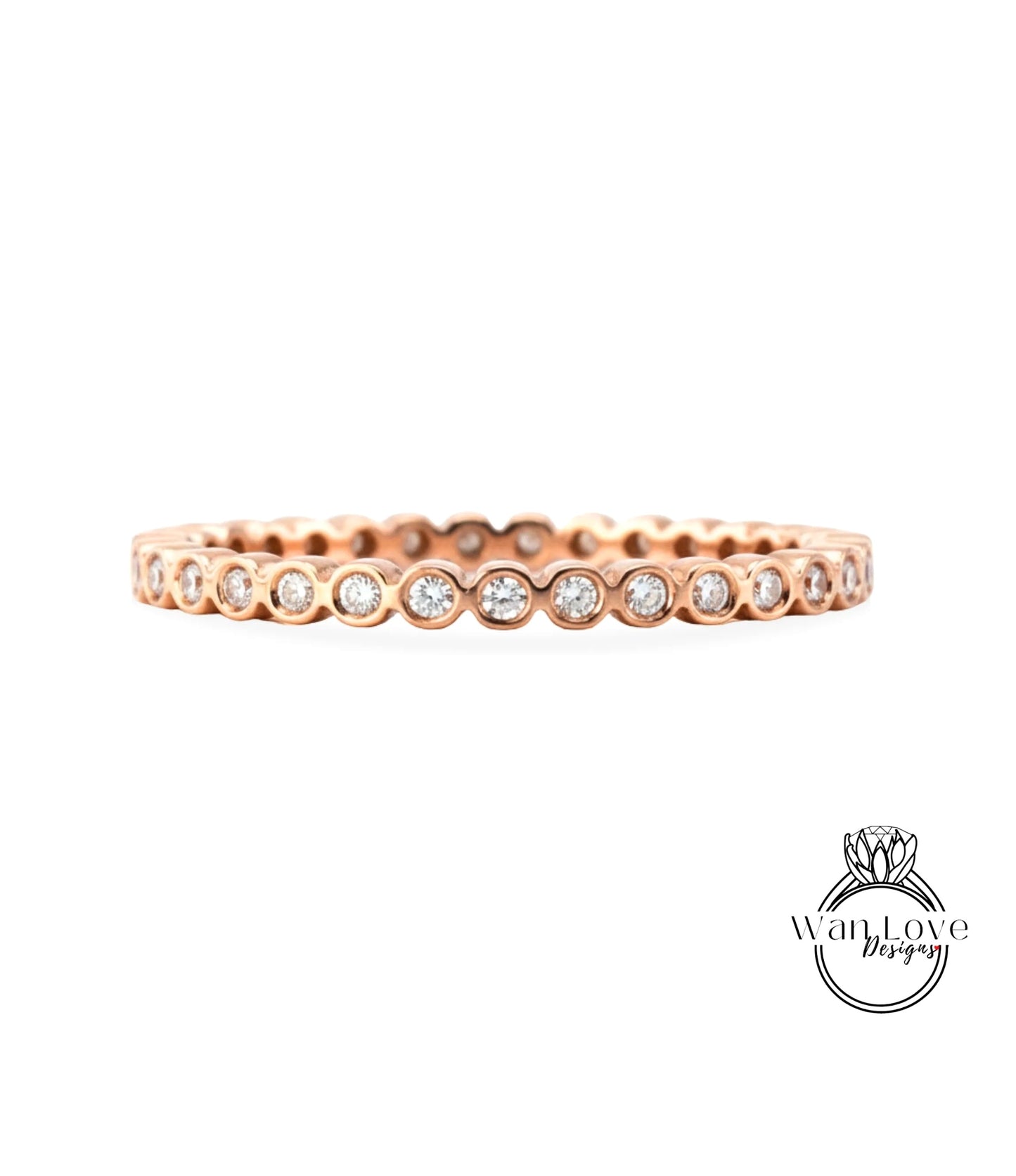 A rose gold ring with a row of small diamonds set in the center.