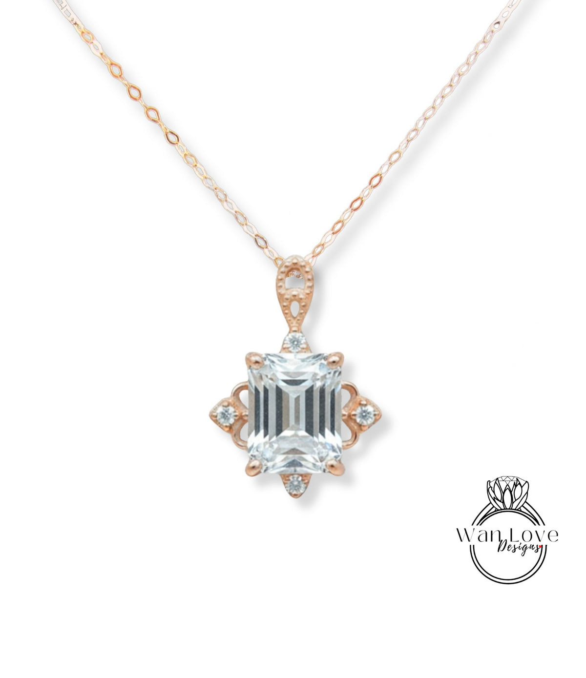 A necklace with a large, clear gemstone pendant, which appears to be a diamond. The pendant is set in a rose gold-colored metal and has an intricate design around it.