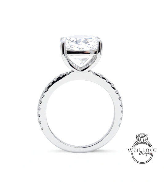 A large, clear diamond engagement ring with a large central diamond and a smaller diamond band around the base.