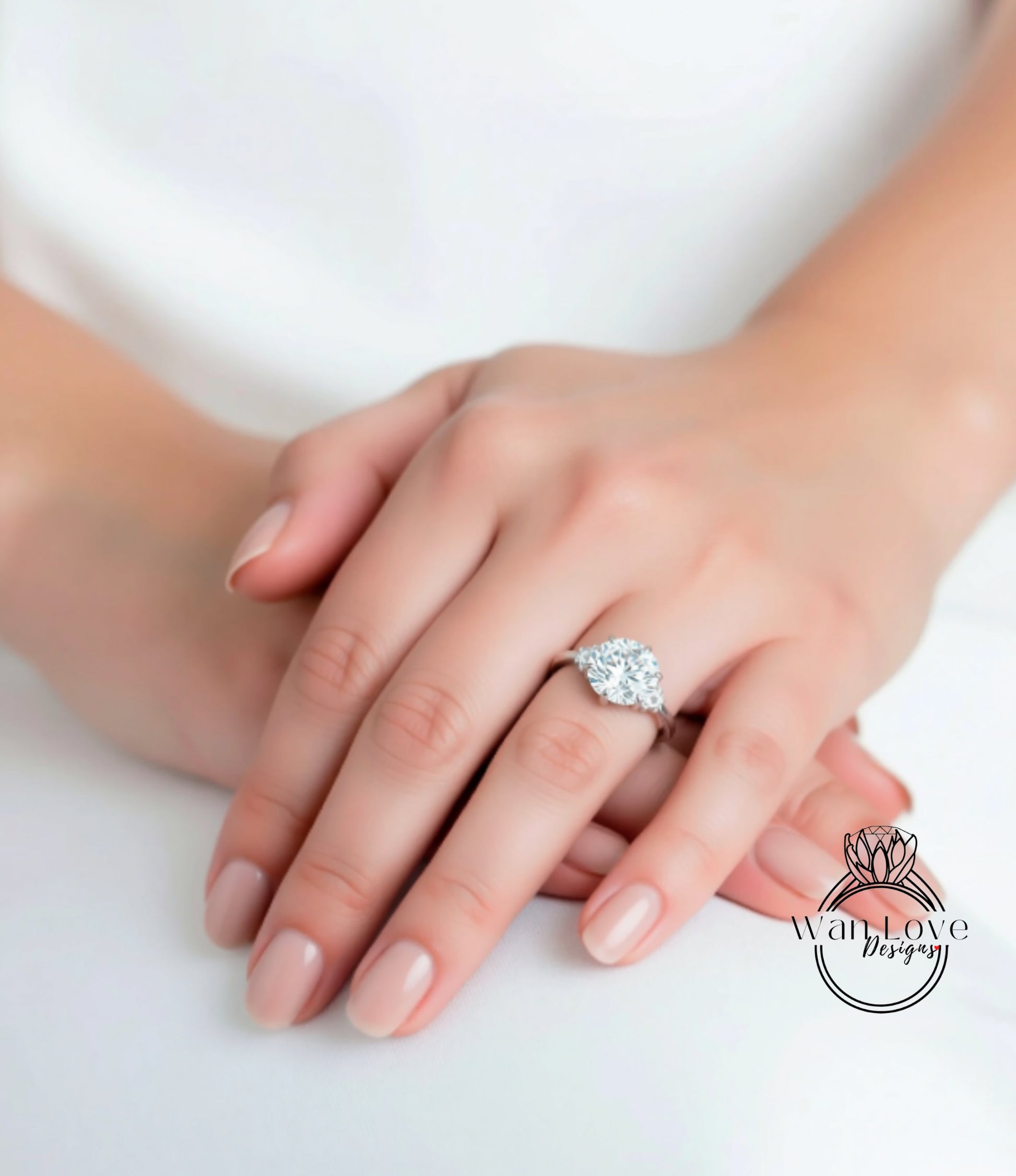 A close-up of a person's hand wearing a diamond engagement ring.