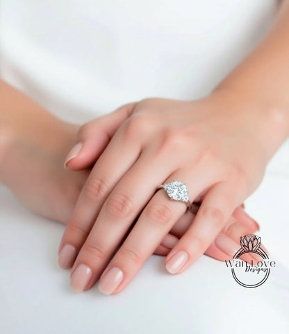A close-up of a person's hand wearing a diamond engagement ring.