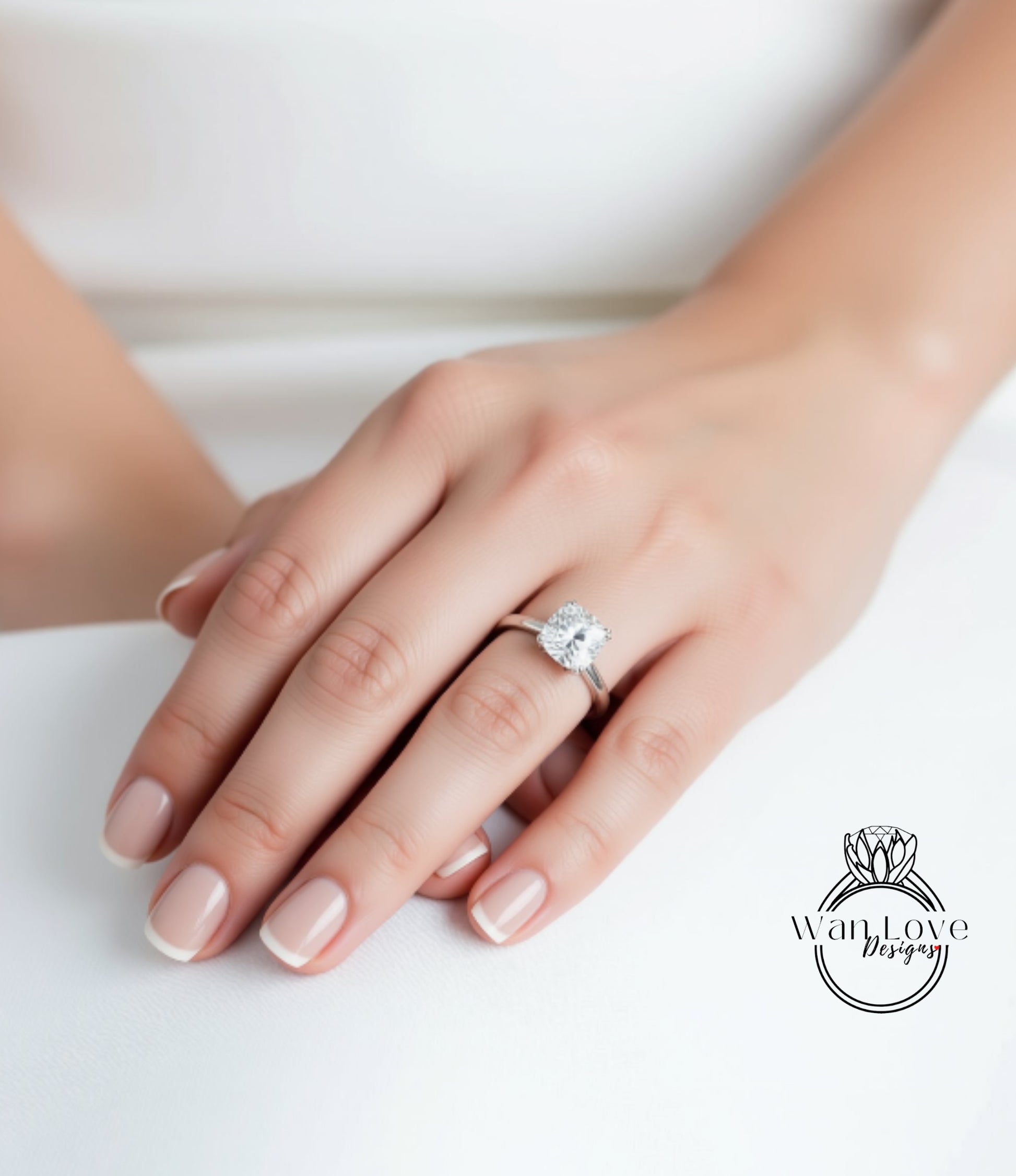 A close-up of a person's hand wearing a diamond engagement ring.