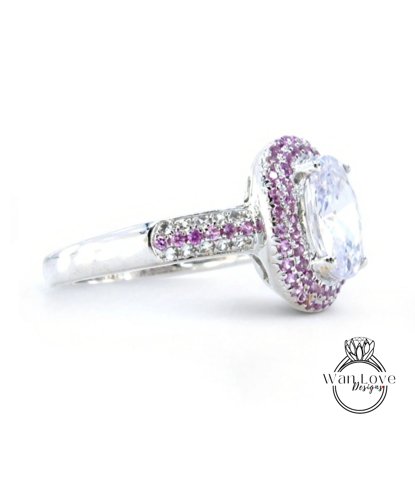 A silver ring with a large, clear gemstone at the center, surrounded by a border of smaller, purple gemstones.