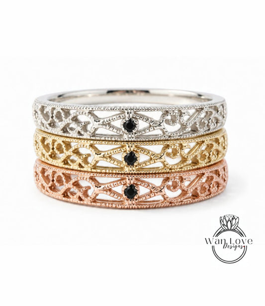 A three-band ring with intricate designs in silver, gold, and rose gold.