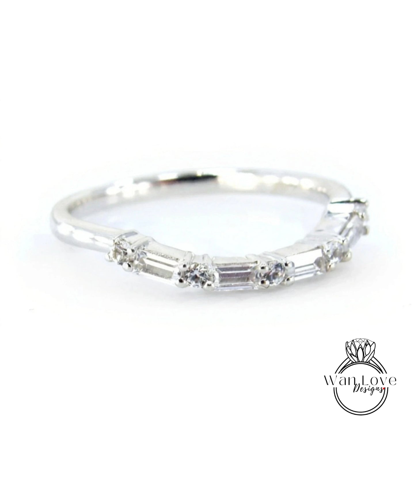 A silver ring with a row of small diamonds set in it.