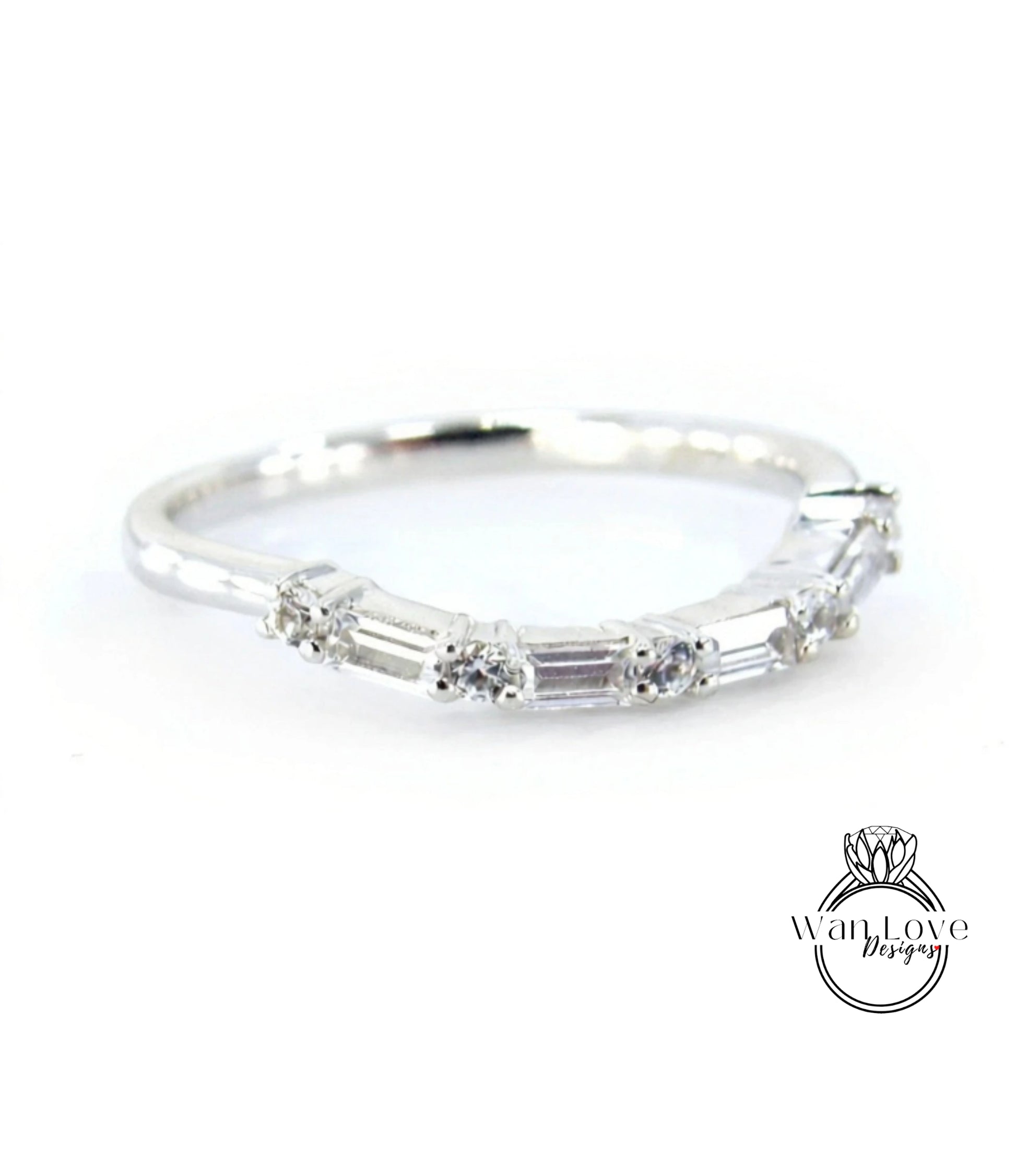 A silver ring with a row of small diamonds set in it.