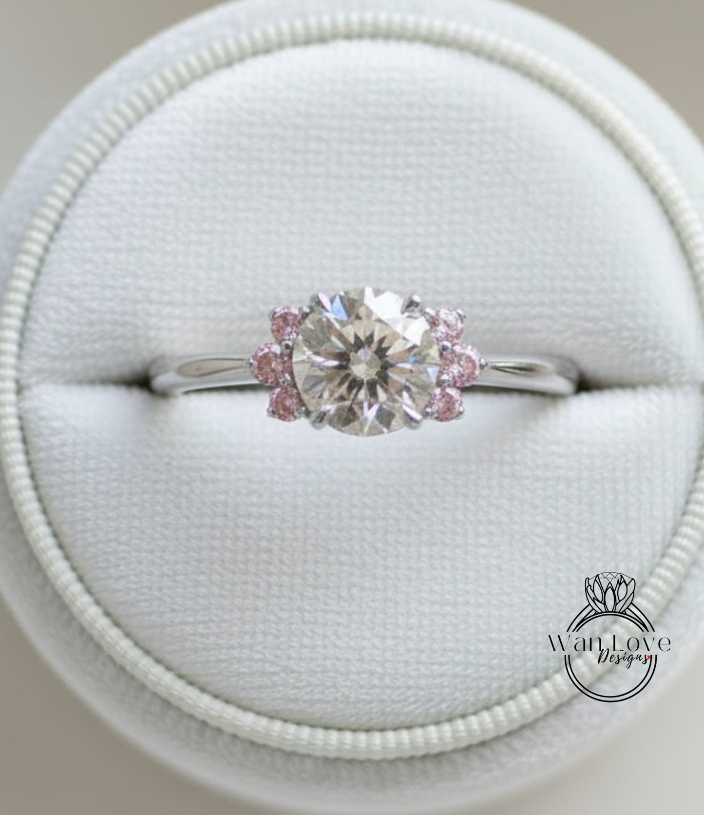 A close-up view of a diamond engagement ring displayed in a white jewelry box.