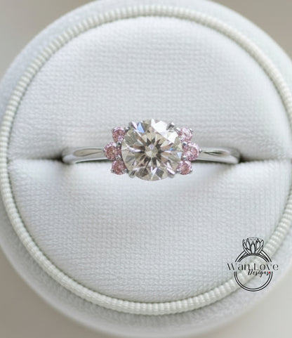 A close-up view of a diamond engagement ring displayed in a white jewelry box.