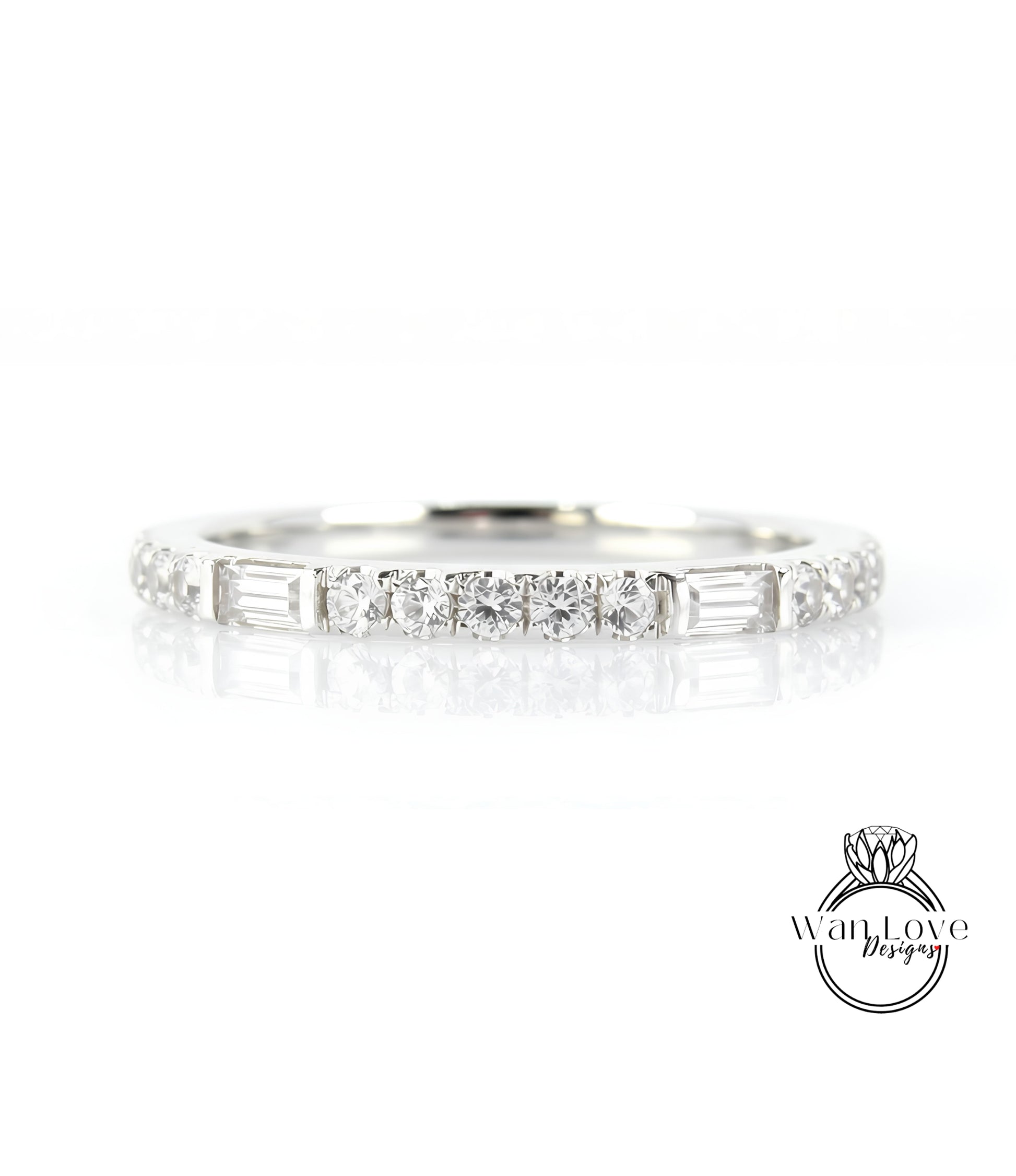 A silver ring with a row of small diamonds set in it, reflecting light and creating a shiny appearance.