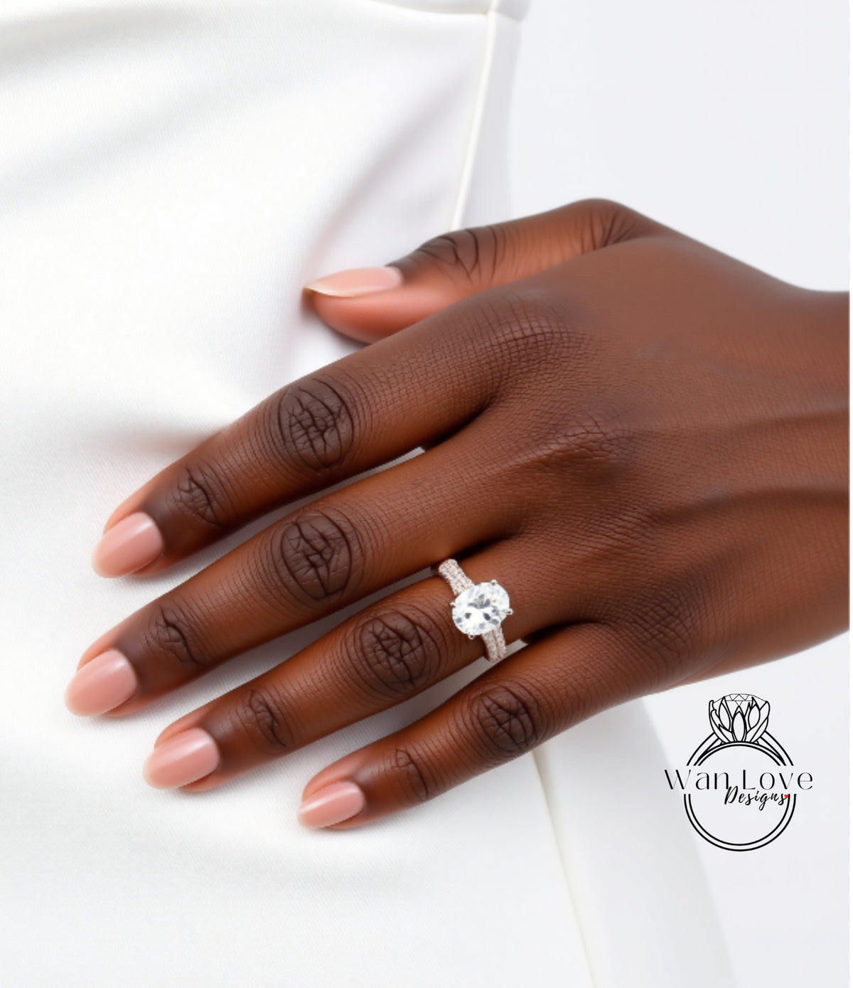 A close-up of a hand wearing a diamond engagement ring.