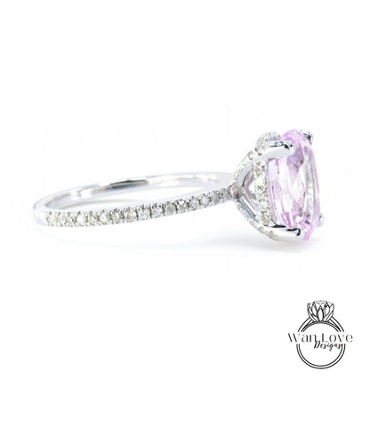 A close-up view of a diamond engagement ring with a large oval-shaped gemstone set in a silver band.