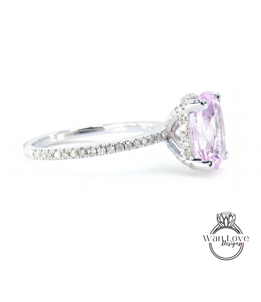 A close-up view of a diamond engagement ring with a large oval-shaped gemstone set in a silver band.