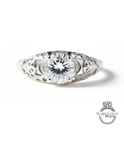 A close-up view of a silver ring with a large, clear gemstone set in the center.