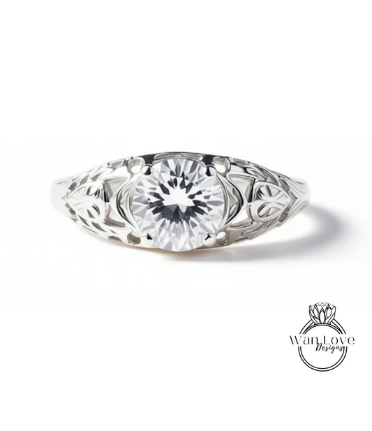 A close-up view of a silver ring with a large, clear gemstone set in the center.