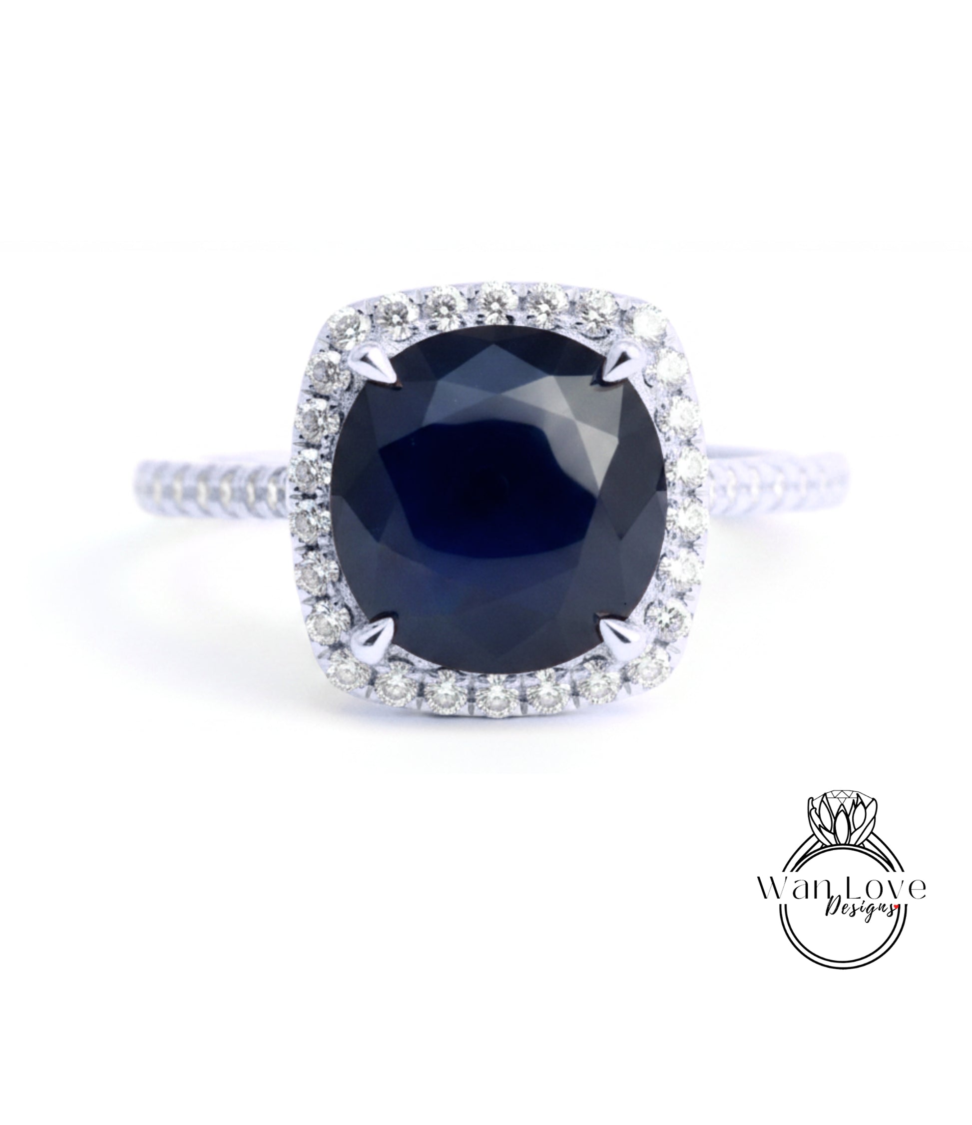 A stunning diamond engagement ring with a large, deep blue gemstone set in a halo of smaller diamonds.
