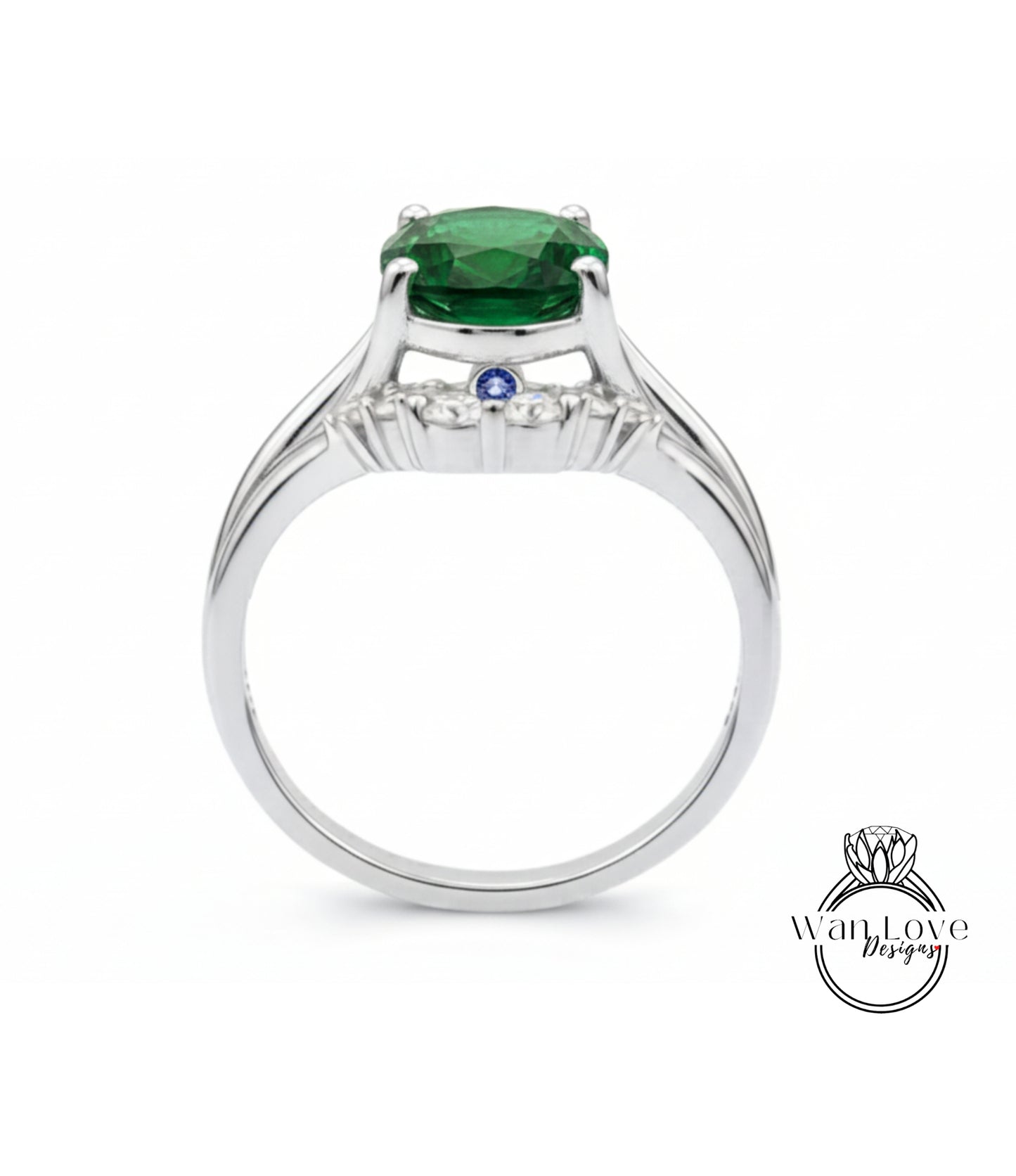 A silver ring with a large green gemstone, possibly a diamond, set in the center.