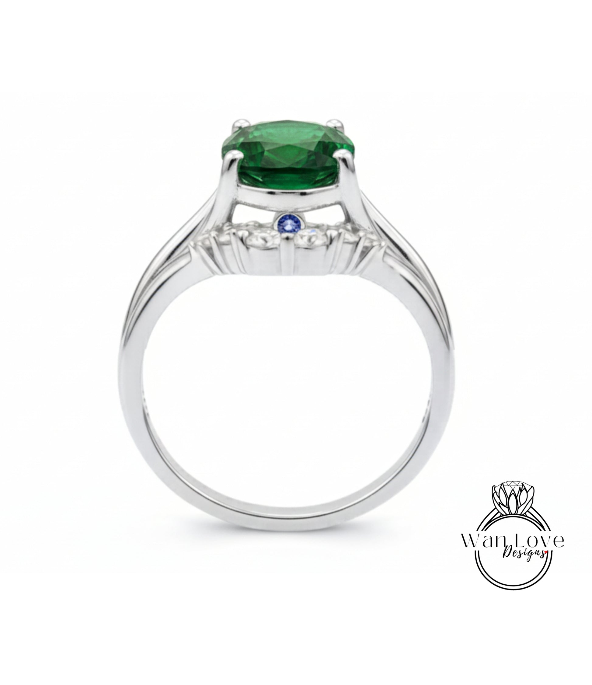 A silver ring with a large green gemstone, possibly a diamond, set in the center.
