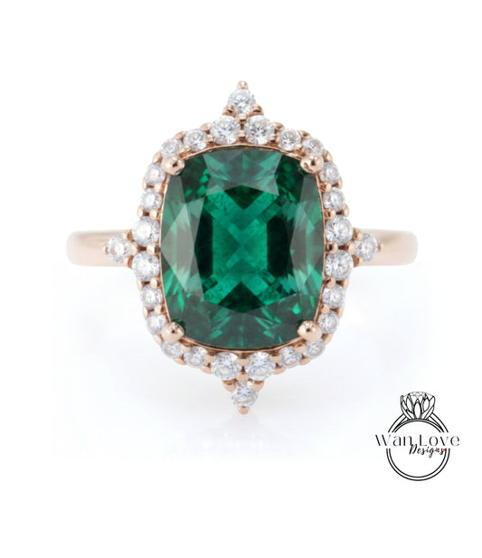A large, oval-shaped green gemstone set in a gold ring with a halo of smaller diamonds around it.