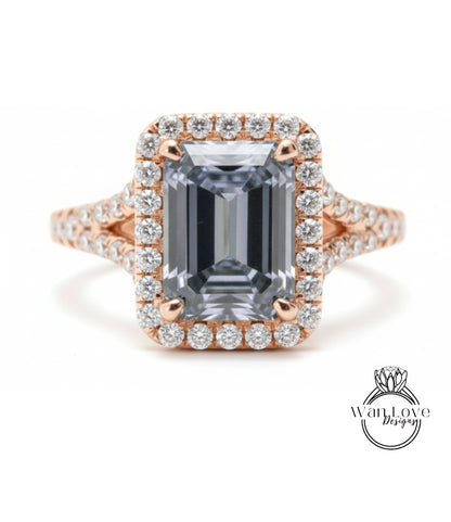 A large, rectangular diamond ring with a halo of smaller diamonds around the center stone.