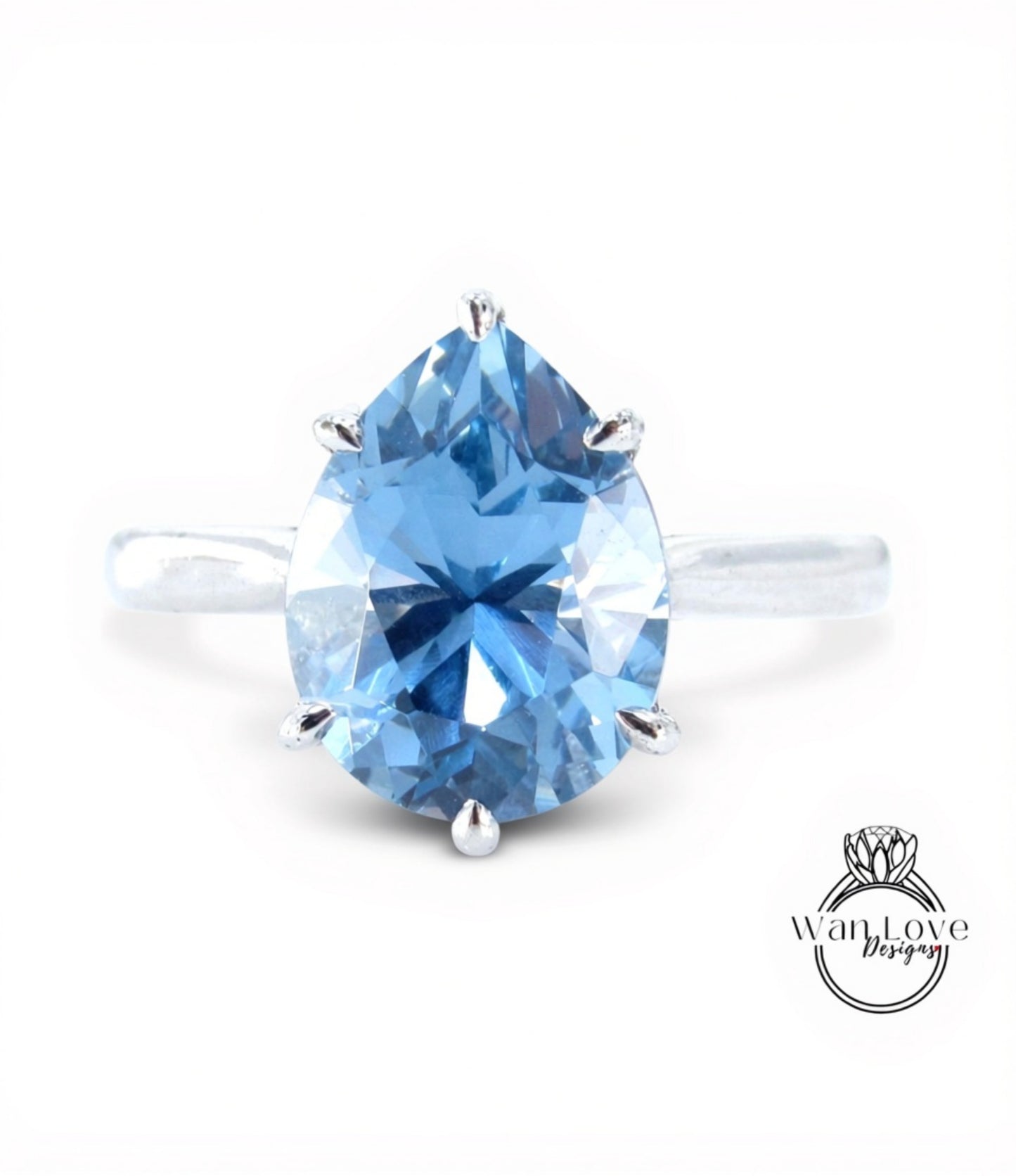 A close-up image of a blue diamond ring with a large, clear gemstone set in a silver band.